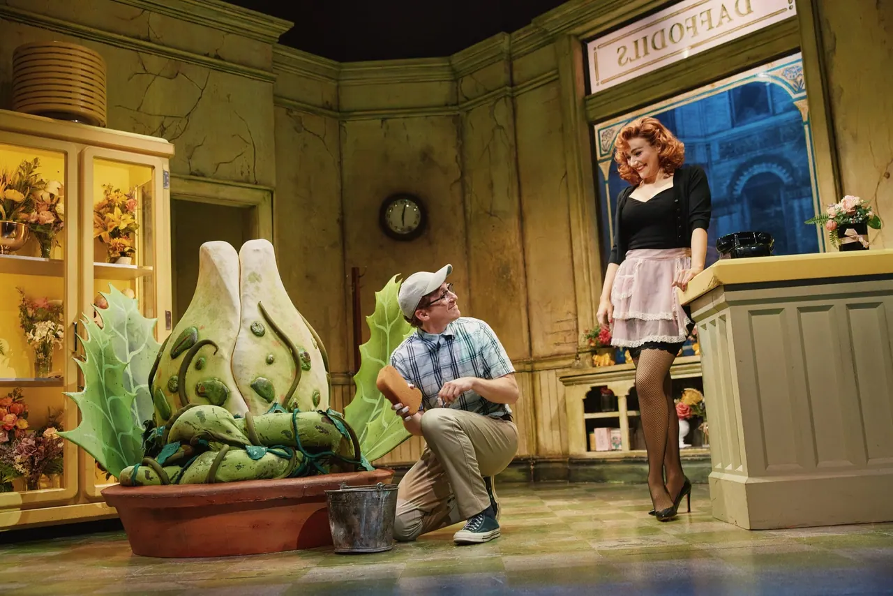 The Audrey II plant puppet and cast of Little Shop of Horrors