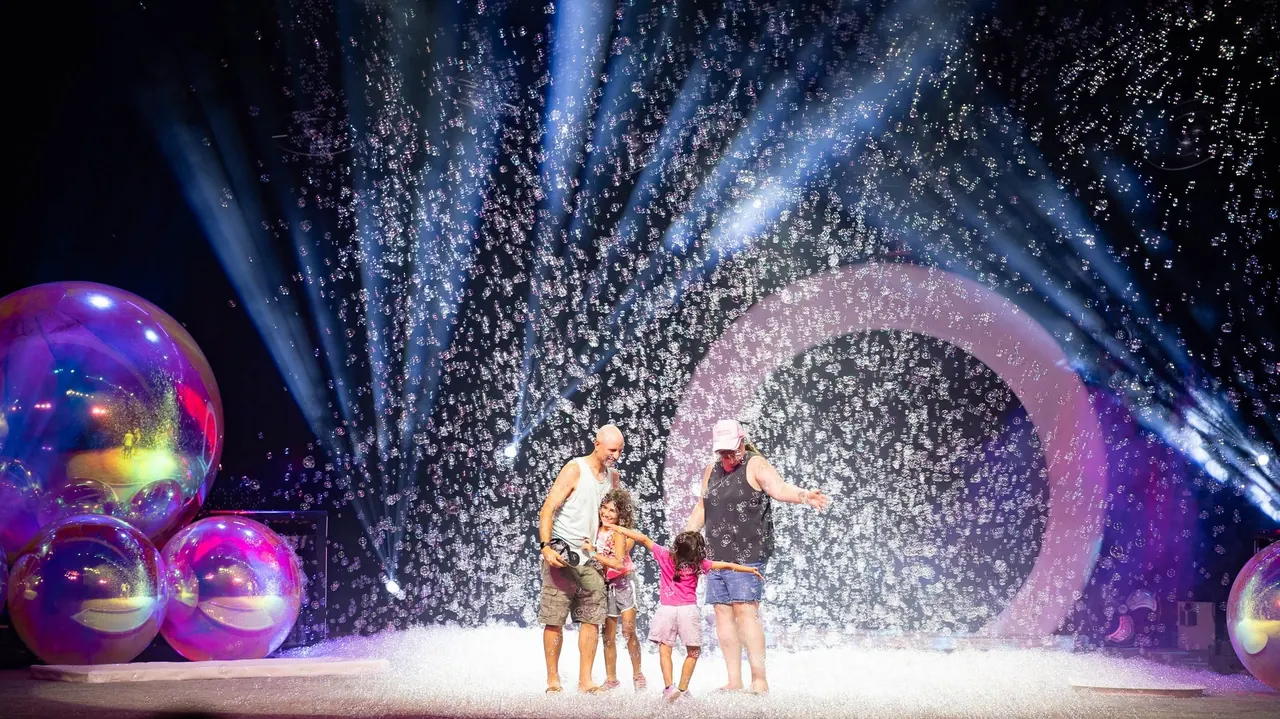 Children and a performer surrounded by bubble effects at The Gazillion Bubble Show